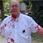 Activists hanging photos of hostages attacked in Frankfurt