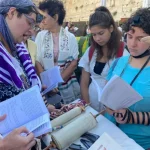 Women of the Wall use soldier to bring Torah to Western Wall plaza