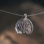 Rare 1,300-year-old lead pendant decorated with a menorah uncovered on Temple Mount