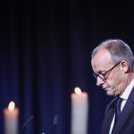 German chancellor urges ‘peaceful coexistence,’ a year after deadly market attack