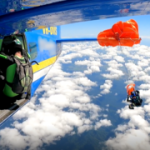 Horror at 20,000 feet: skydiver left hanging from plane wing after sudden parachute deployment