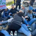 Protesters tie themselves to each other outside court