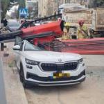 Woman killed after crane truck topples in Jerusalem amid strong winds