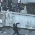 Security guard arrested after throwing stones at protest