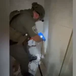 Security forces break wall and find hidden weapon