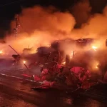 Firefighting crews battle blaze at vehicle lot in Kiryat Arba